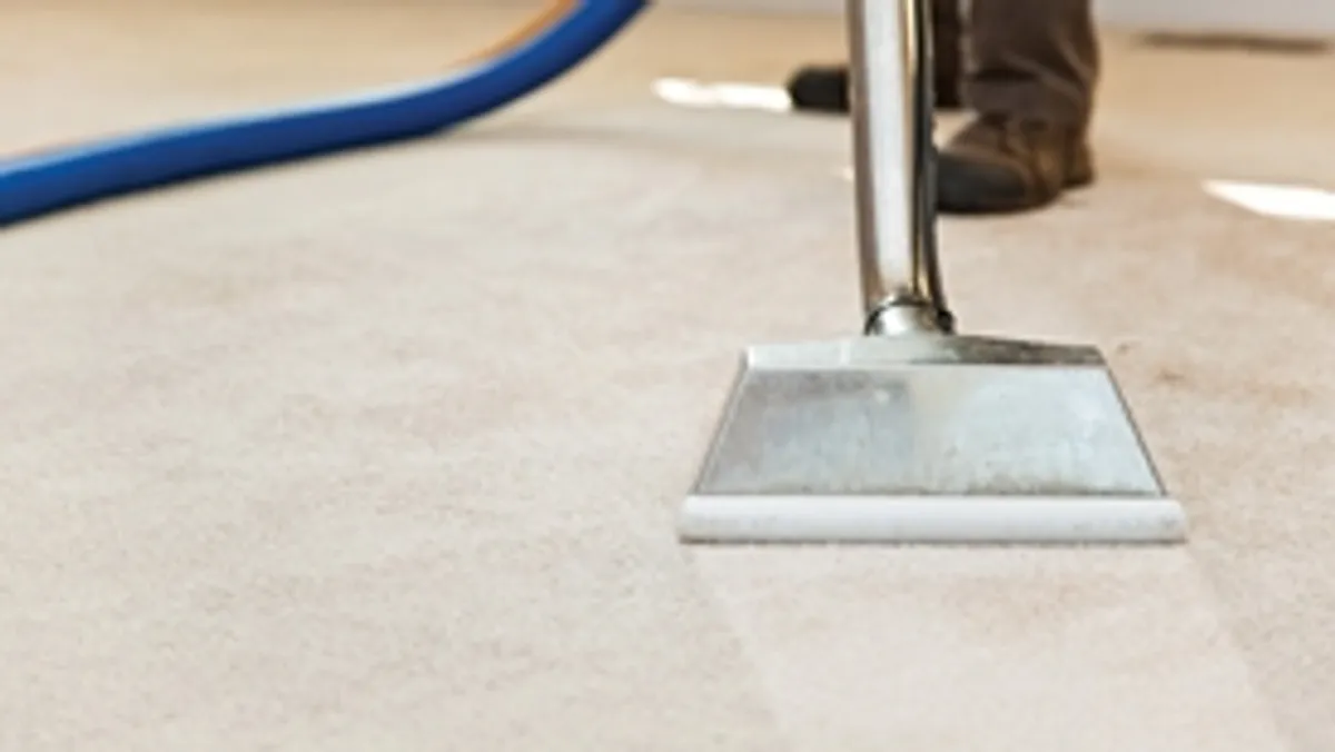 Carpet cleaning wand head gliding over a light carpet during hot-water extraction, Mobile, AL.